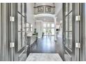 Grand foyer with soaring ceilings, dark hardwood floors and elegant architectural details at 3233 Bagley Psge, Duluth, GA 30097