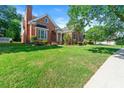 Beautiful brick home boasts a lush green lawn and neatly trimmed landscaping at 1272 Saxony Se Dr, Conyers, GA 30013