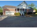 Brick home with attached garage, a covered front porch, and sidewalk at 1272 Saxony Se Dr, Conyers, GA 30013