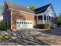 Brick home featuring an attached garage with driveway, and covered front porch at 1272 Saxony Se Dr, Conyers, GA 30013