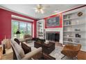 Cozy living room featuring a fireplace, built-in bookshelves, and a large window with natural light at 1272 Saxony Se Dr, Conyers, GA 30013