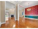 Traditional living room featuring hardwood floors, fireplace and large windows at 1272 Saxony Se Dr, Conyers, GA 30013