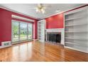 Bright living room with hardwood floors, a fireplace, built-in bookshelves, and natural light at 1272 Saxony Se Dr, Conyers, GA 30013