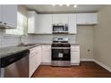 Modern kitchen featuring white cabinets, stainless steel appliances, and granite countertops at 2386 Mills Bnd, Decatur, GA 30034