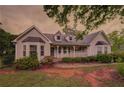 Charming two-story home with a well-maintained lawn and welcoming front porch at 4715 Hill Rd, Powder Springs, GA 30127
