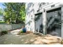 Exterior shot of two gray doors with a small window and a blue pot with plants at 1234 Weatherstone Ne Dr, Atlanta, GA 30324