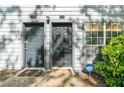 Exterior shot of two gray doors and a small window with a home security sign displayed at 1234 Weatherstone Ne Dr, Atlanta, GA 30324