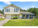 Charming two-story home with a well-maintained lawn, stone accents, and a covered front porch at 1248 To Lani Ct, Stone Mountain, GA 30083