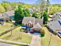 Aerial view of a charming home with a well-maintained lawn and mature trees in a suburban neighborhood at 3049 Battlement, Loganville, GA 30052