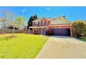 Beautiful two-story home boasting a well-maintained lawn, brick facade, and inviting curb appeal at 3049 Battlement, Loganville, GA 30052