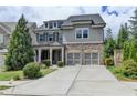 Beautiful two-story home with a brick and gray shingle exterior and a two-car garage at 11210 Easthaven Pl, Duluth, GA 30097