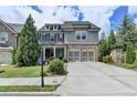Beautiful two-story home with a brick and gray shingle exterior and a two-car garage at 11210 Easthaven Pl, Duluth, GA 30097