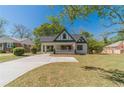 Charming cream and green house featuring a manicured lawn, covered carport, and classic architectural details at 181 W Hightower Trl, Social Circle, GA 30025
