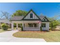 Attractive cream and green home with a covered carport, manicured lawn, and charming curb appeal at 181 W Hightower Trl, Social Circle, GA 30025