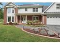 Close up of a home's front entrance with landscaping, brick accents, and a well-maintained lawn at 2156 Fairway Cir, Duluth, GA 30096