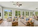 Sunroom featuring large windows, tile floors, comfortable seating, and views of the backyard at 2156 Fairway Cir, Duluth, GA 30096