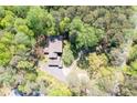 A beautiful aerial view of a house nestled in a dense, green forest canopy at 3141 Burnt Hickory Nw Rd, Marietta, GA 30064