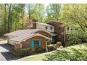 Brick two-story home with a well-manicured lawn and unique architectural details at 3141 Burnt Hickory Nw Rd, Marietta, GA 30064