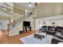 Open floor plan showcasing a staircase, fireplace, and a seamless transition to the kitchen at 3870 Cabalzar St, Cumming, GA 30040