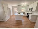 Modern kitchen with white cabinets, stainless steel appliances, and hardwood floors at 563 Hillandale Circle Sw, Marietta, GA 30064