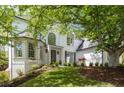 Stately white brick home with well-manicured lawn, beautiful landscaping, and classic architectural details at 648 Gold Valley Pass, Canton, GA 30114