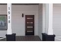 Modern front door with glass inserts, painted columns, and the house number on the column at 1515 Jonesboro Rd, Atlanta, GA 30315