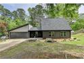 Charming home featuring a two-car garage and complemented by landscaping, offering both convenience and curb appeal at 226 Sandra Nw Dr, Lilburn, GA 30047