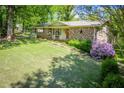 Charming brick home with a well-maintained front yard and blooming bushes at 3224 Laura Way, Winston, GA 30187