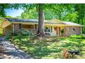 Ranch-style home with brick exterior, covered porch, and well-maintained lawn with mature trees at 3224 Laura Way, Winston, GA 30187