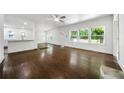 Bright living room features hardwood floors, large windows, and an open layout to the kitchen at 3460 Old Fairburn Rd, South Fulton, GA 30349