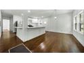 Spacious living room featuring hardwood floors, recessed lighting, and an open floor plan to the kitchen at 3460 Old Fairburn Rd, South Fulton, GA 30349