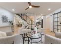 Bright and airy living room featuring hardwood floors, modern decor, and an open staircase at 3840 Wieuca Ne Ter, Atlanta, GA 30342