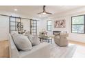 Stylish living room showcasing a decorative fireplace, sleek furnishings, and large windows for natural light at 3840 Wieuca Ne Ter, Atlanta, GA 30342