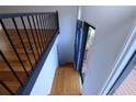 Foyer with blue door, wood floors and wrought iron railing and staircase leading to the second floor at 4270 Mountain Glen Trce, Snellville, GA 30039
