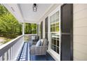 Relaxing porch with comfortable seating and a view of the wooded surroundings at 6005 Cherecobb Ln, Woodstock, GA 30188