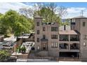 Stunning exterior view of brick home, showcasing a spacious outdoor patio and garage at 631 Boulevard Ne, Atlanta, GA 30308