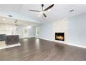 Inviting living space featuring hardwood floors, a stone fireplace, and an open layout with abundant natural light at 319 Primrose Ln, Auburn, GA 30011