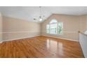 Bright bedroom with hardwood floors, vaulted ceiling, and a large window at 4512 Terret Nw Trce, Acworth, GA 30101