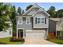 Charming two-story home featuring gray siding, a two-car garage, and a well-manicured front lawn at 458 Burgundy Se Ter, Atlanta, GA 30354