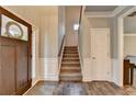 Welcoming foyer featuring hardwood floors, staircase, and paneled walls for a classic look at 3419 Mulberry Cove Way, Auburn, GA 30011