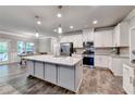 Modern kitchen with stainless steel appliances, granite countertops, and a large central island at 3419 Mulberry Cove Way, Auburn, GA 30011