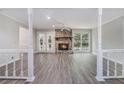 Spacious living room features a stone fireplace, hardwood floors, and large windows for plenty of natural light at 1373 Janice Sw Ct, Lilburn, GA 30047