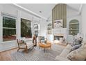 Inviting living room with hardwood floors, a fireplace, built-in shelving, and ample natural light at 1481 Wild Rye Ln, Grayson, GA 30017