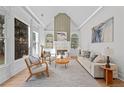 Bright living room featuring vaulted ceilings, built-in shelving, large windows, and a cozy fireplace at 1481 Wild Rye Ln, Grayson, GA 30017