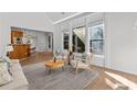 Open-concept living room with views of the kitchen, large windows, and modern furniture at 1481 Wild Rye Ln, Grayson, GA 30017