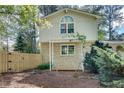 Back of a brick home with a small deck and a wooden privacy fence at 1631 Manhasset Dr, Atlanta, GA 30338