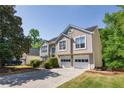 Beautiful home featuring a 2-car garage, landscaped front yard, and classic architectural details for a suburban lifestyle at 3140 Ennfield Ln, Duluth, GA 30096