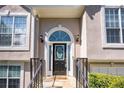 Close up of a beautiful home's front door with decorative glass, elegant sidelights and stylish exterior lighting at 3140 Ennfield Ln, Duluth, GA 30096