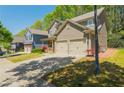 Two-story home with a well-maintained lawn and driveway leading to a two-car garage at 127 Stoney Creek Pkwy, Woodstock, GA 30188