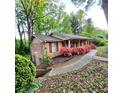 Brick home with lush green landscaping and a cozy, covered front porch at 1901 Arnold Dr, Austell, GA 30106